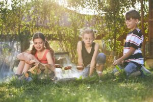 children enjoy campfire